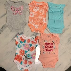 5 NB girl onesies set. New. Colors are peaches, gray, white, pinks, blue